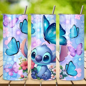 May include: A cylindrical stainless steel tumbler featuring a light blue background with a pattern of pink and blue flowers, purple and blue butterflies, and a blue cartoon character holding a pink flower, topped with a thin metal straw.