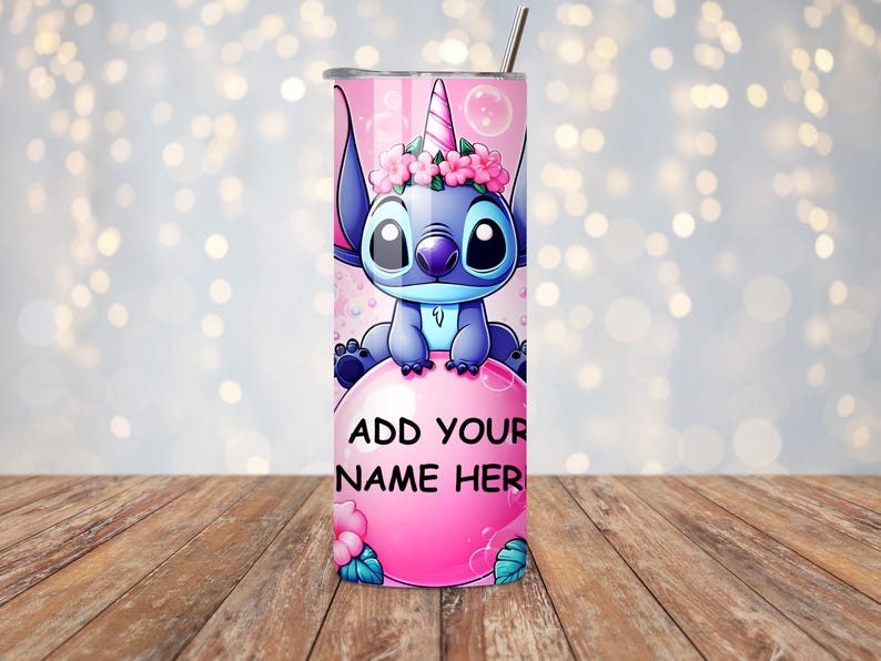May include: A pink and blue tumbler featuring a cartoon character with a unicorn horn and flower crown. The tumbler has the text "ADD YOUR NAME HERE" on a pink bubble. A silver straw is included.