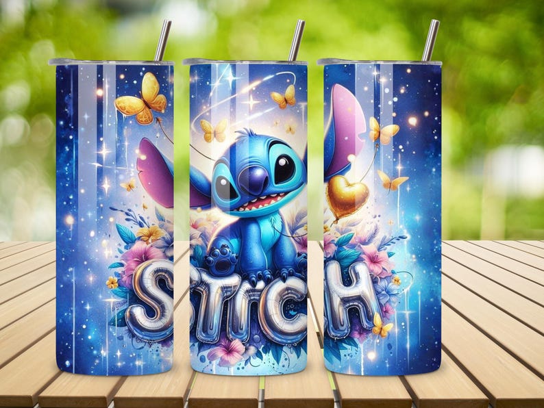 May include: A blue tumbler featuring the character Stitch, surrounded by butterflies, flowers, and the word "STITCH" in silver balloon letters. The design includes a starry background and a silver straw.