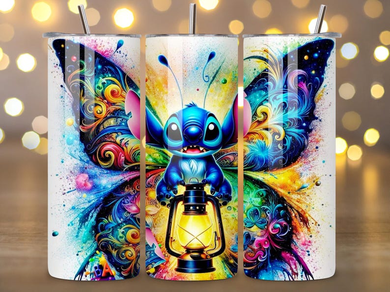 May include: A set of three stainless steel tumblers featuring a vibrant design. The design showcases a blue cartoon character with large eyes, holding a lantern, and set against colorful butterfly wings. The tumblers have a silver straw and lid.