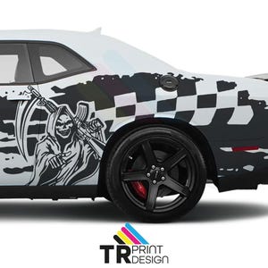 May include: White car with a black and white graphic design. The design features a grim reaper holding a scythe and a rifle, with a checkered flag pattern. The car has black wheels and red brake calipers.