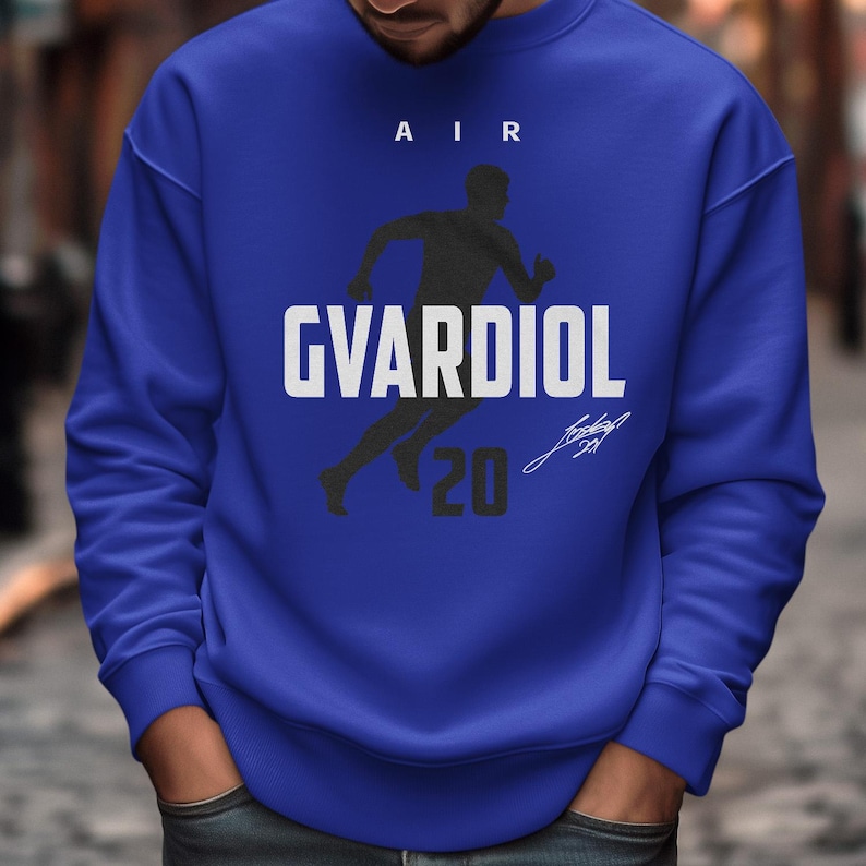 A man wearing a blue sweatshirt with a graphic design on it.