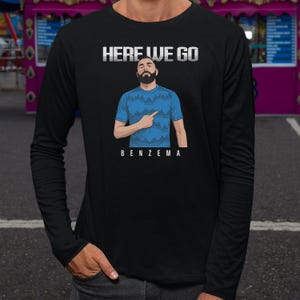 a man wearing a black long-sleeved shirt with a graphic design on it.