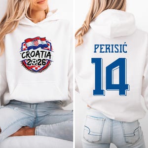 A white hoodie with a graphic of the Croatia national flag and the text "CROATIA 2026" printed on it. The back of the hoodie has the number "14" and the name "PERISIC" printed on it.