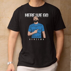 a man wearing a black t-shirt with a graphic design and text printed on it.