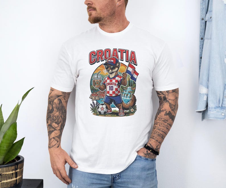 A man wearing a white t-shirt with a graphic of a soccer player and the word "Croatia" printed on it.