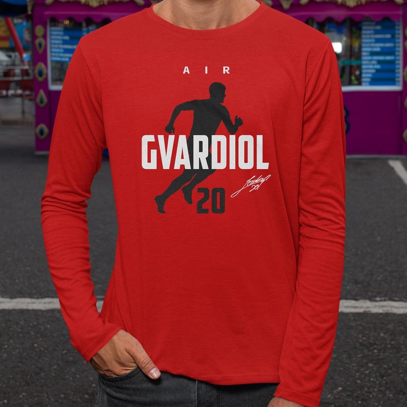 A person wearing a red long-sleeved shirt with a graphic design featuring a silhouette of a person running and the text "AIR GVARDIOL 20" printed on it.