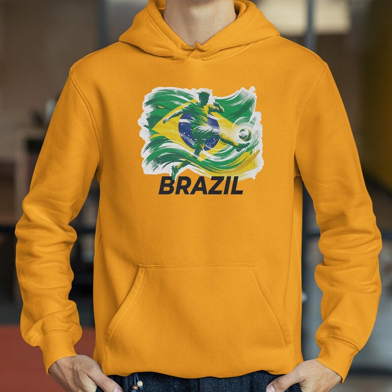 A yellow hoodie with a graphic of a soccer player and the word "BRAZIL" printed on it.