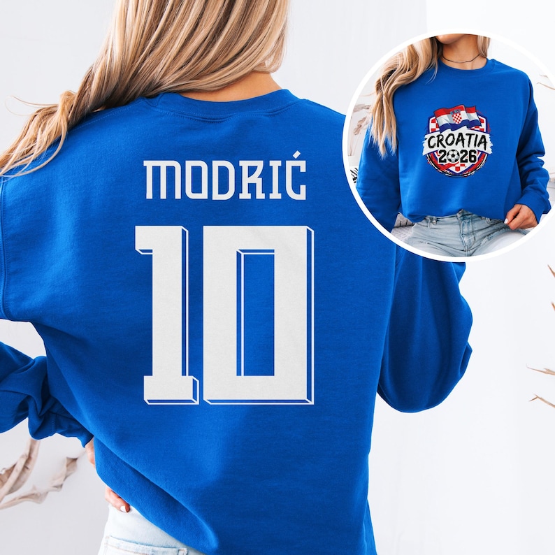 A woman wearing a blue sweatshirt with the number 10 and the name "Modric" printed on it.