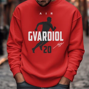 A man wearing a red sweatshirt with a graphic design on it.