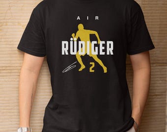 Camiseta unisex de fútbol estilo Air Rudiger #2 Alemania, diseño animado del Mundial de EE. UU. 2026, regalo de apoyo para aficionados a jugadores estrella de fútbol.