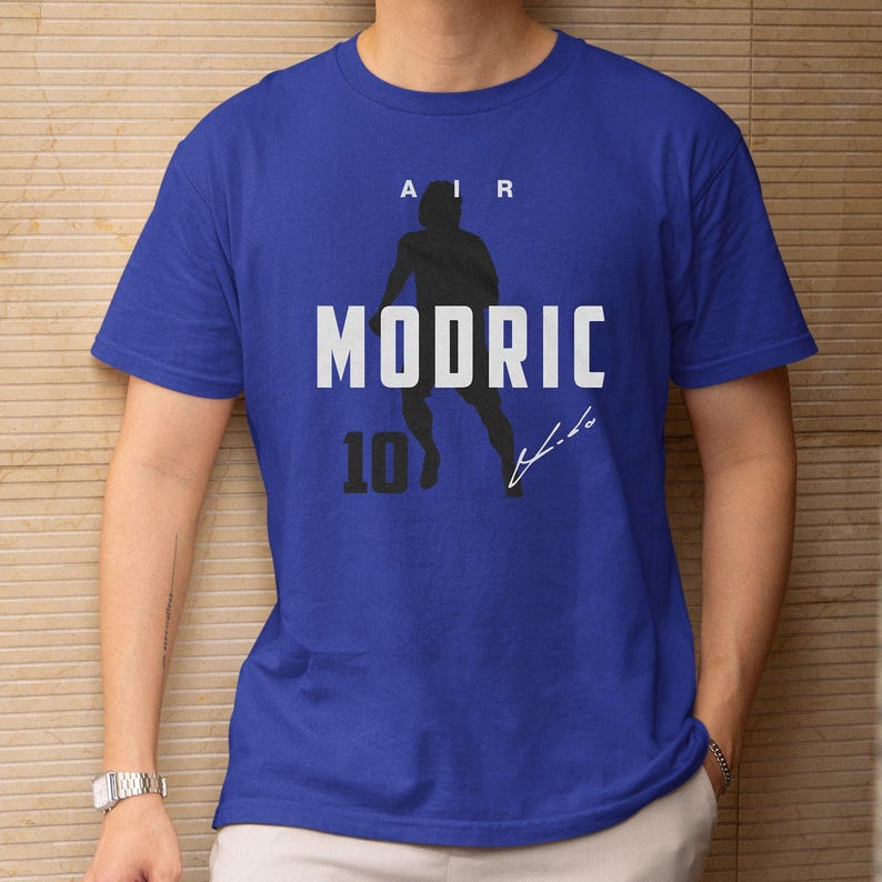 A blue t-shirt with a graphic design featuring a silhouette of a person and the text "AIR MODRIC 10" printed on it.
