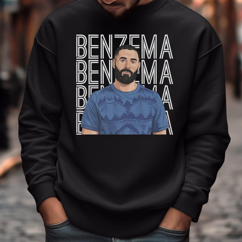 A man wearing a black sweatshirt with a graphic design featuring the word "BENZEMA" repeated multiple times.