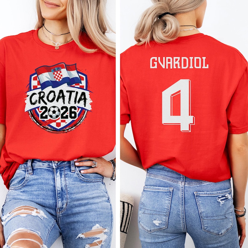 A woman wearing a red t-shirt with a graphic of the Croatia national flag and the text "Croatia 2026" printed on it.