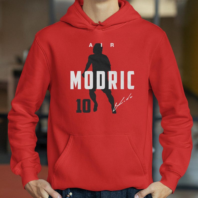 A red hoodie with a graphic design featuring a silhouette of a person running and the text "MODRIC 10" printed on it.
