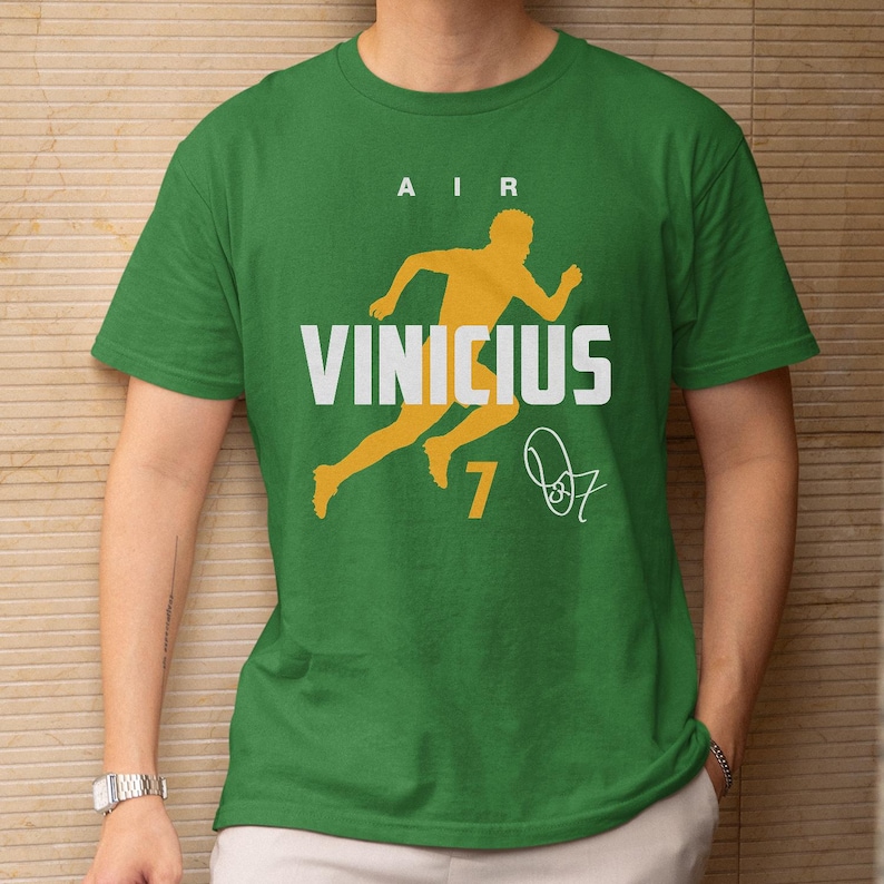 A green t-shirt with a yellow graphic and text printed on it.