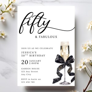 May include: A white invitation card with the words "fifty & FABULOUS" in black script. The invitation includes details for Jessica's 50th birthday, a champagne glass with a black bow, and floral accents.