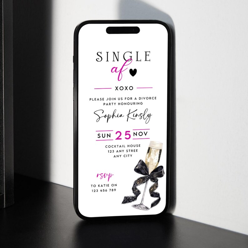 May include: A smartphone displays a divorce party invitation. The invitation features the text "SINGLE af" in black and pink, along with event details including the honoree's name, date, time, and RSVP information. A champagne glass with a black bow is also shown.