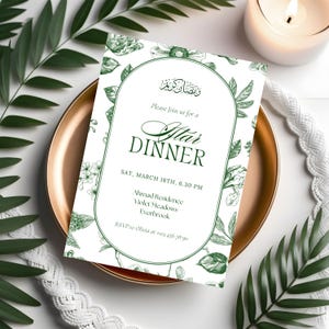 May include: An invitation for an Iftar dinner, featuring green floral illustrations and text. The invitation is on a white background, surrounded by a gold plate, greenery, and a lit candle. The text includes the date, time, and location.