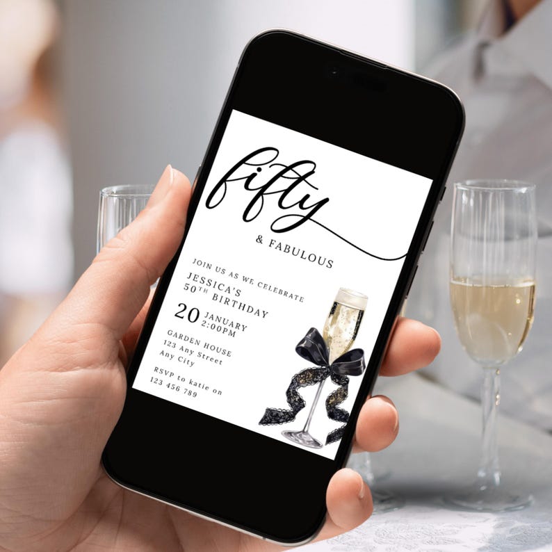 May include: A smartphone displays a digital invitation for a 50th birthday celebration. The invitation features elegant script that reads "fifty & FABULOUS." A champagne glass with a black bow and ribbon is illustrated on the invitation. The date is January 20th.
