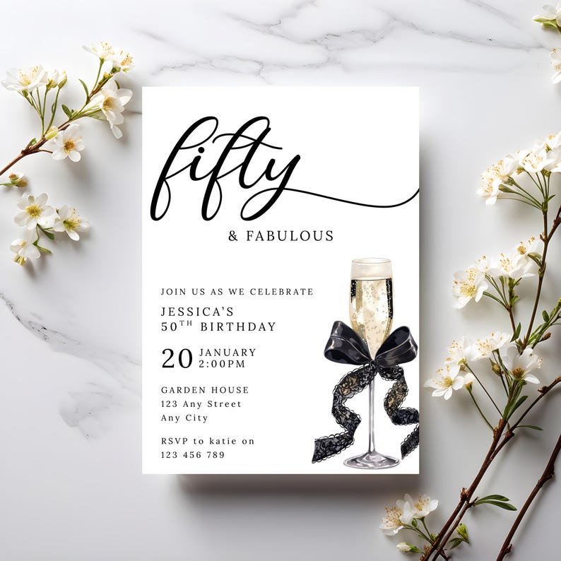 May include: A white invitation card with the words "fifty & FABULOUS" in black script. The invitation includes details for Jessica's 50th birthday, a champagne glass with a black bow, and floral accents.