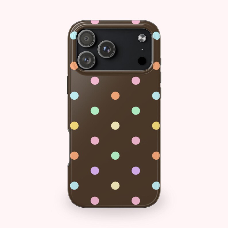 May include: A brown phone case with a repeating pattern of colorful polka dots in pastel shades of pink, yellow, orange, green, and blue. The case has a camera cutout and side buttons.