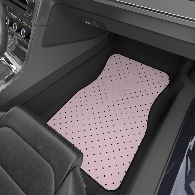 trendy pink polka dot car mats, pink car accessories. Set of four pink car floor mats with a black polka dot pattern. The set includes two front mats and two rear mats, all with a black border.