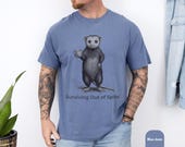 Photo 6 of 8: Blue jean comfort colors shirt with a quirky possum illustration and the phrase Surviving Out of Spite, a funny opossum tee with dark humor and introvert humor appeal, perfect novelty graphic tee for a gift for him or anyone who loves sarcastic animal humor shirts