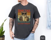 Photo 2 of 8: White garment-dyed unisex dad weasel shirt with warm retro sunset stripes and a cheeky illustrated weasel holding fries and a drink with the caption DAD TAX making sure it's not poison, a funny dad tee and novelty dad gift shirt perfect for Father's Day and everyday dad life
