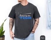 Photo 2 of 8: Man wearing a vintage wash tee with the phrase touched by the tism in bold blue lettering, a funny autism shirt and neurodivergent shirt styled for casual everyday wear or an ASD awareness gift