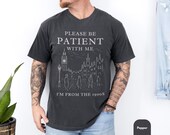 Photo 2 of 8: Folded charcoal unisex t shirt with faded serif graphic reading Please be patient with me over a sketched city skyline, soft vintage wash and cozy feel, funny vintage shirt inspired by shirts from the 1900s, retro humor tee with sarcastic t shirt vibe, perfect novelty graphic tee and gift for him or dad and old soul wardrobe