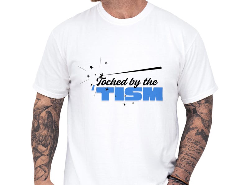 White vintage wash tee with bold “touched by the tism” graphic in blue and black, styled for neurodivergent shirt and autism humor shirt fans, a funny autism tee with a clean modern look and great as an ASD awareness gift