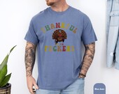 Photo 6 of 8: Outdoorsy man wearing a dark unisex humor tee with a colorful turkey graphic and bold "thankful for you" cheeky message, playful inappropriate friendsgiving shirt and funny thanksgiving gift for friends, cozy layered look for casual holiday gatherings