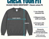 Photo 12 of 20: A fitting guide showing a dark gray Gildan 18000 crewneck sweatshirt with measurement arrows indicating chest width and length.