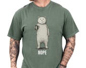 Photo 1 of 8: White unisex funny bear shirt showing a sketched bear holding a coffee mug with bold NOPE caption, a minimalist sarcastic t shirt perfect for introvert humor and coffee humor shirt lovers, styled on a tattooed model for cozy everyday novelty graphic tee gift for him