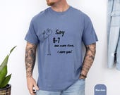 Photo 6 of 8: Blue jean relaxed unisex stick figure tee with a minimalist doodle and bold printed phrase "Say 6-7 one more time, I dare you" — a funny dare shirt and I dare you shirt with a playful youthful casual vibe, perfect teacher gift tee or parent gift tee for teacher appreciation and gag gift feel