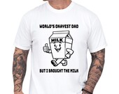 Photo 1 of 8: Funny dad shirt with a playful milk carton art graphic and the phrase World’s Okayest Dad, making a lighthearted fathers day gift or gift for dad for a cool papa outfit that celebrates the cereal run joke and family gag clothes vibe