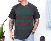 Photo 3 of 7: Unisex cotton tee mockup showing five available colors on a relaxed male model, black, white, pepper, moss and blue jean, for a funny Christmas T-shirt featuring a cheeky Jesus scarecrow graphic, soft cozy feel and casual fit ideal as a gift for him or her this holiday