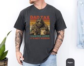 Photo 2 of 8: White soft cotton dad tax t shirt with vintage sunset stripes and a humorous sasquatch illustration holding fries and a drink reading "making sure it's not poison", a funny dad shirt and dad gift tee perfect for camping trips, cozy weekends and birthday surprises
