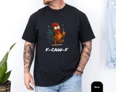 Photo 3 of 8: Soft Comfort Colors graphic tee in faded blue jean showing a cheeky cartoon rooster flipping a middle finger with bold F-CAW-F lettering, an edgy funny t shirt for casual streetwear lovers, cozy statement tee and adult humor gift for him or gift for dad