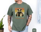 Photo 5 of 8: Soft garment dyed tee in faded blue jean with a vintage striped graphic of a sunglasses-wearing badger holding fries and a drink, bold DAD TAX headline and cheeky it's not poison line, a funny dad tax shirt and badger dad tee perfect as a Father's Day gift