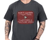 Photo 1 of 8: Man modeling a worn-in charcoal Comfort Colors soft cotton tee with a distressed red retro play button graphic that reads a cheeky YouTube DIY meme, cozy casual funny dad shirt idea and handyman gift or Fathers Day tee for him
