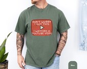 Photo 5 of 8: Outdoor lifestyle photo of a man leaning on a mountain bike wearing a comfort colors shirt featuring a retro red play button and funny youtube shirt slogan, soft cotton tee styled as a funny dad shirt and handyman gift, ideal fathers day tee and gift for dad