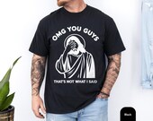 Photo 3 of 8: Black unisex funny tshirt with a Jesus facepalm graphic and the quote omg you guys that’s not what I said, a playful christian humor tee with a clean vintage wash look, great as a gift for christians or gift for him