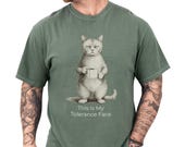 Photo 1 of 8: Moss green unisex t shirt on a tattooed male model featuring a vintage grumpy cat holding a coffee mug with the caption This Is My Tolerance Face, a funny cat shirt and cat meme tee with dry, sarcastic humor, cozy soft feel, novelty cat tee and cat lover gift for him