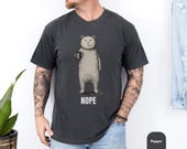 Photo 2 of 8: Soft moss green unisex t shirt showing a minimalist bear graphic holding a coffee mug and the bold NOPE text, a funny bear shirt and sarcastic t shirt with introvert humor and coffee humor vibes, ideal novelty graphic tee or cozy gift for him