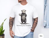 Photo 4 of 8: Charcoal unisex opossum shirt featuring a detailed hand-drawn possum with a sly grin and raised paw and the small "Surviving Out of Spite" slogan — a funny opossum tee and possum meme shirt with dark humor and sarcastic t shirt vibes, an animal humor novelty for introverts and a passive-aggressive gift for him