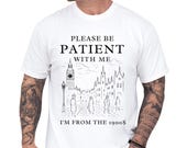 Photo 1 of 8: Relaxed moss green unisex t shirt worn by a tattooed model, featuring a vintage black city sketch and bold lettering reading I'm from the 1900s, soft worn aesthetic and cozy fit, a funny vintage shirt and retro humor tee, novelty graphic tee and sarcastic t shirt gift for him, dad, millennial or Gen X old soul humor apparel