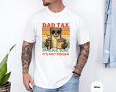 Photo 4 of 8: Garment dyed moss green unisex tee showing a cheeky weasel character holding fries and a soda against retro sunset stripes with bold DAD TAX lettering, a funny dad tee and dad weasel shirt with playful dad joke vibe, perfect father gift idea or Fathers Day shirt for a cozy dad life wardrobe