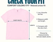 Photo 11 of 17: A light pink t-shirt displayed flat with instructions on how to measure chest width and length for sizing.